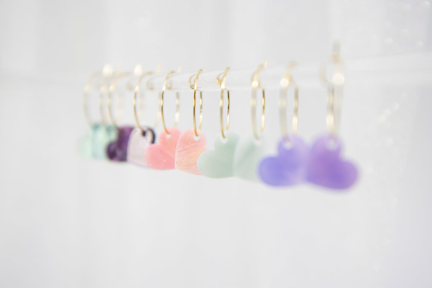 Filigree hoop earrings with heart pendant made of acrylic