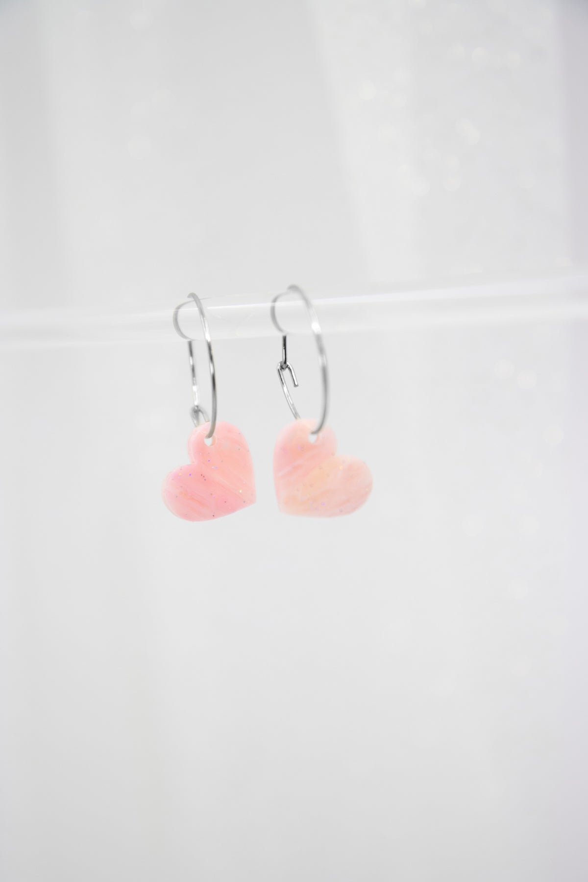 Filigree hoop earrings with heart pendant made of acrylic