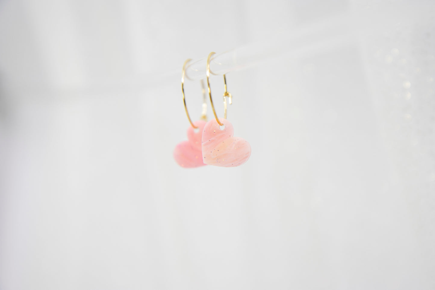 Filigree hoop earrings with heart pendant made of acrylic