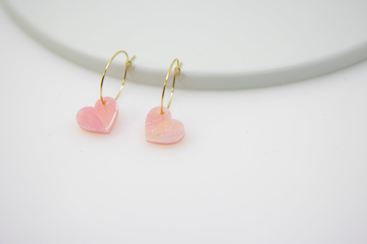 Filigree hoop earrings with heart pendant made of acrylic