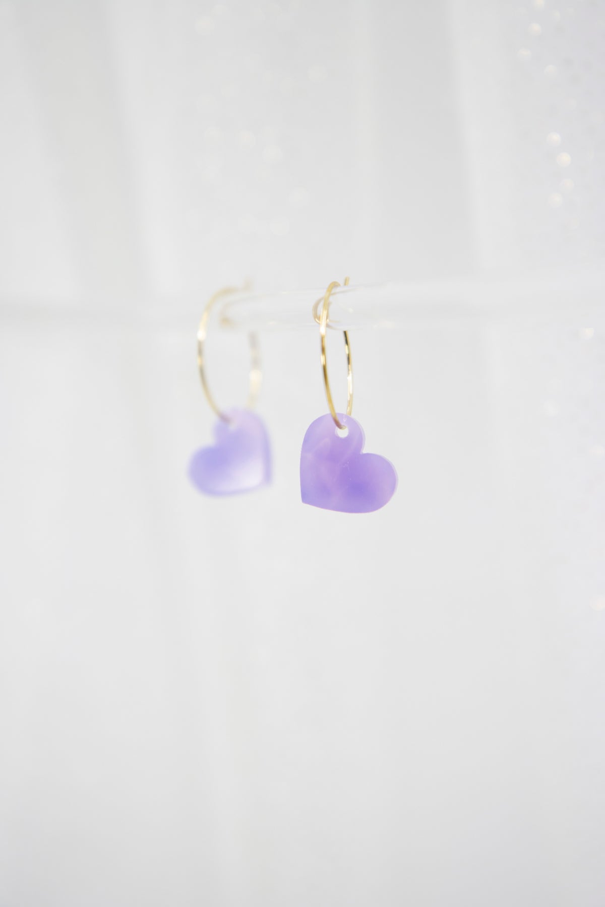 Filigree hoop earrings with heart pendant made of acrylic