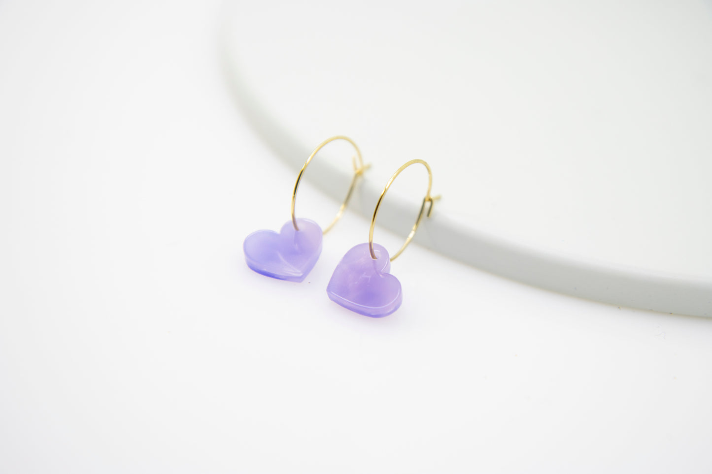 Filigree hoop earrings with heart pendant made of acrylic