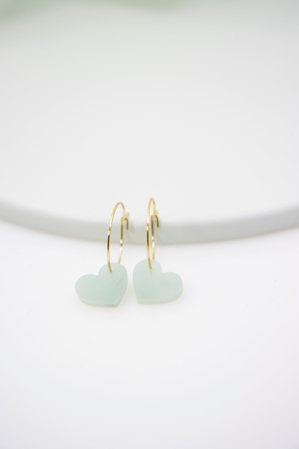 Filigree hoop earrings with heart pendant made of acrylic