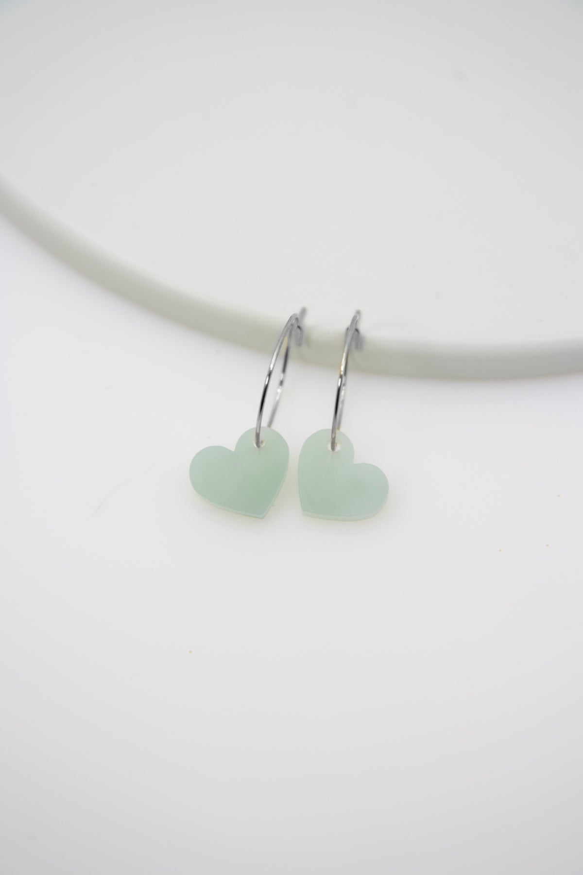 Filigree hoop earrings with heart pendant made of acrylic
