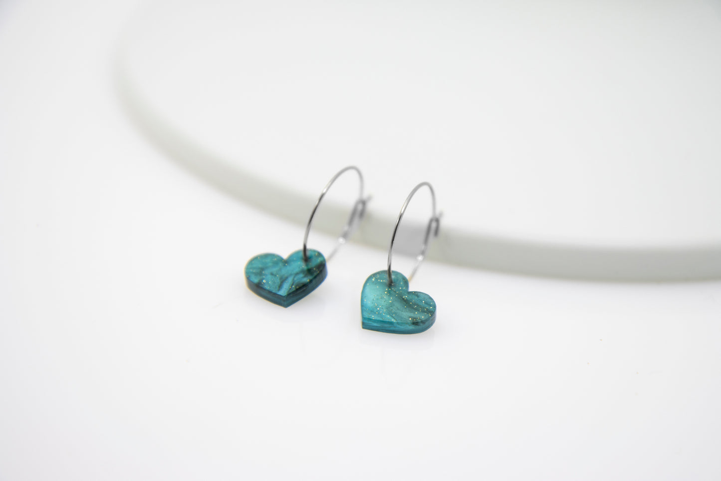 Filigree hoop earrings with heart pendant made of acrylic