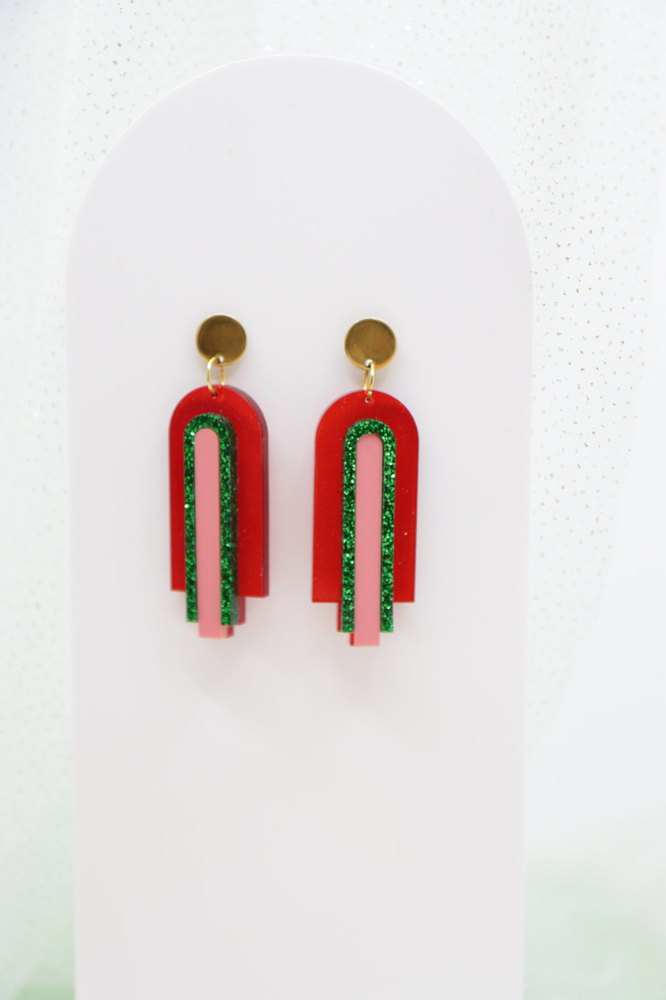 Red, geometric statement earrings made of acrylic in arch shape