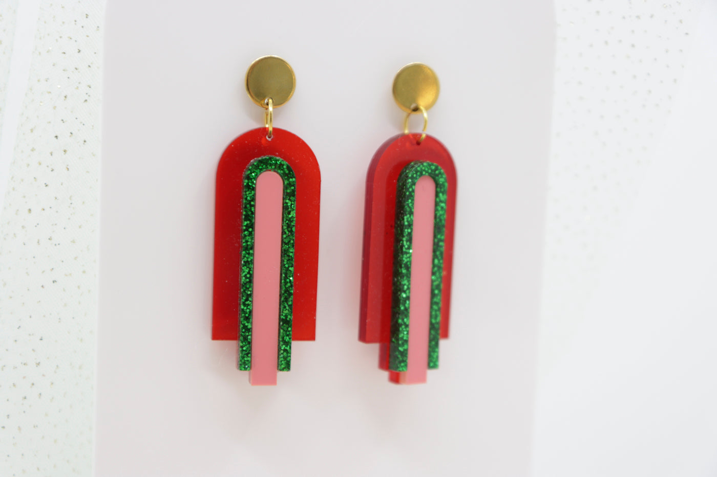 Red, geometric statement earrings made of acrylic in arch shape