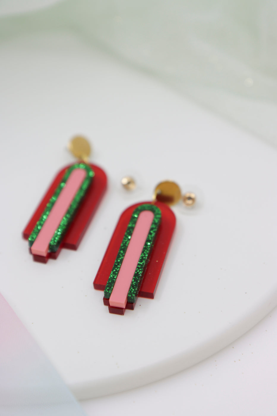 Red, geometric statement earrings made of acrylic in arch shape