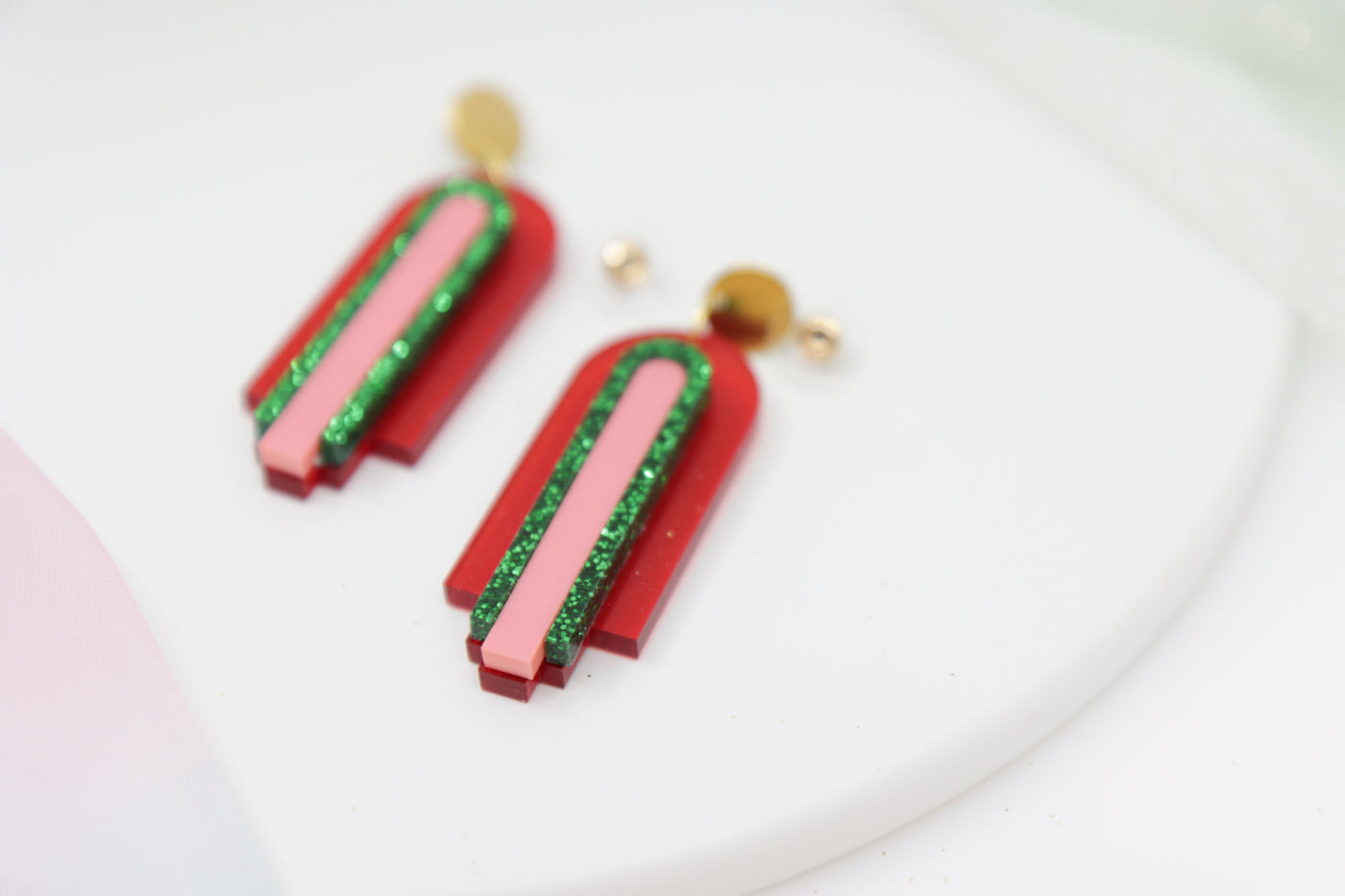 Red, geometric statement earrings made of acrylic in arch shape