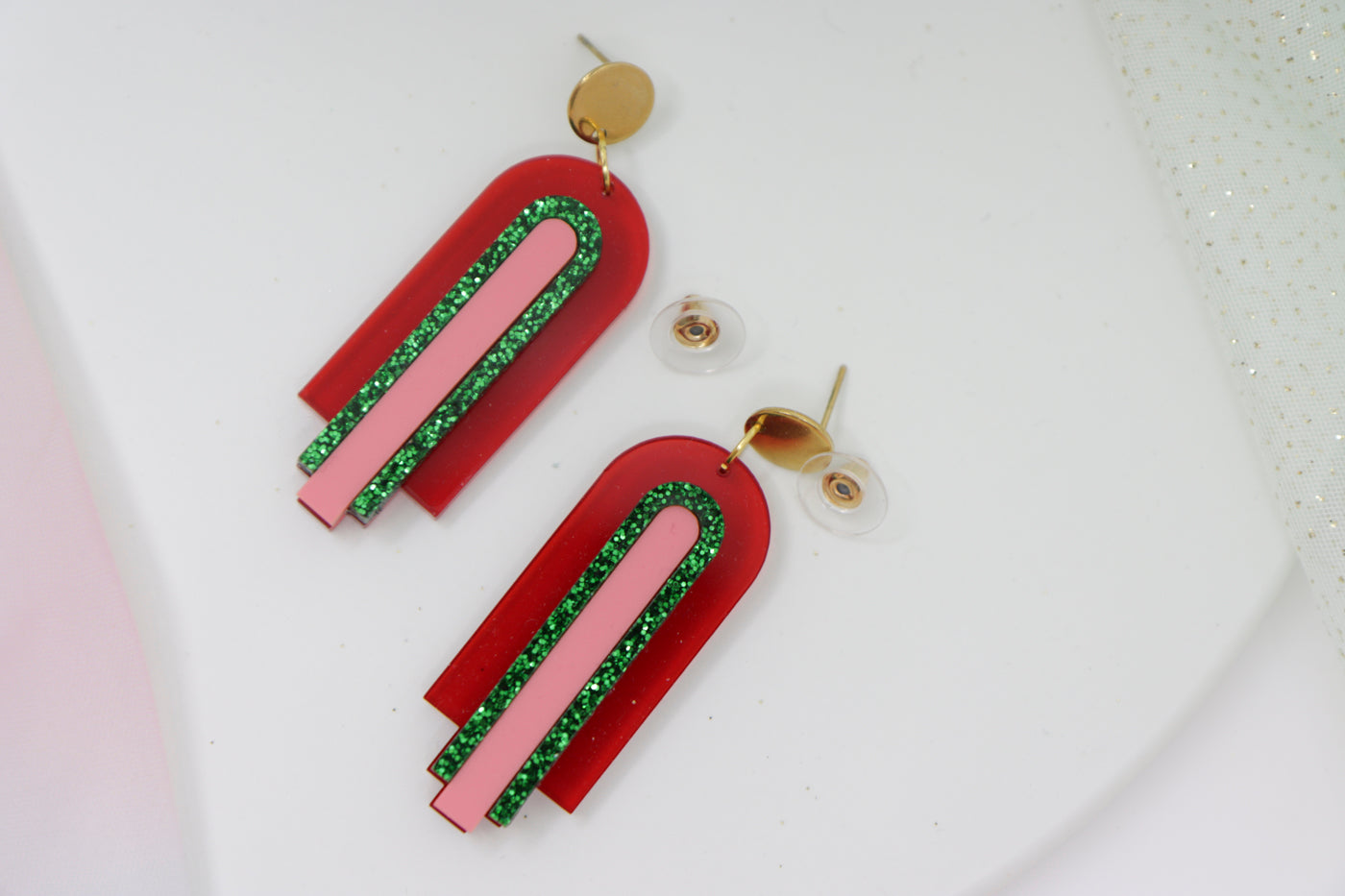 Red, geometric statement earrings made of acrylic in arch shape
