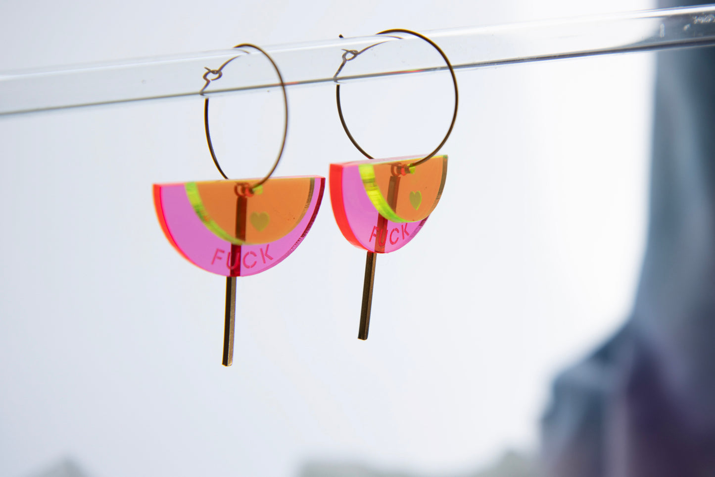 Gold-colored "FUCK" neon acrylic hoop earrings