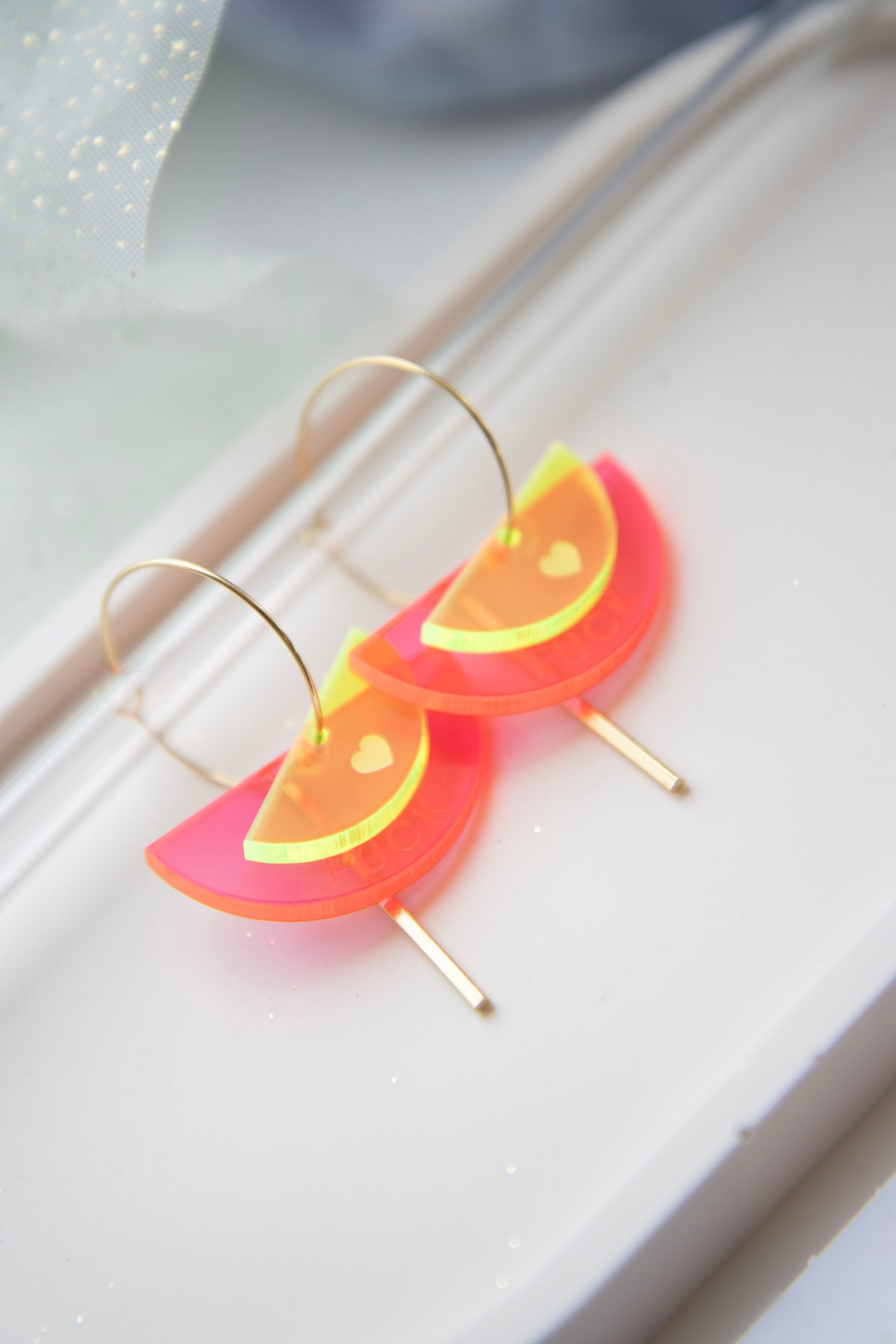 Gold-colored "FUCK" neon acrylic hoop earrings