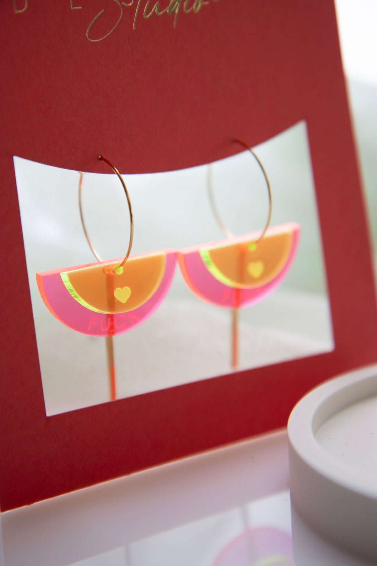 Gold-colored "FUCK" neon acrylic hoop earrings