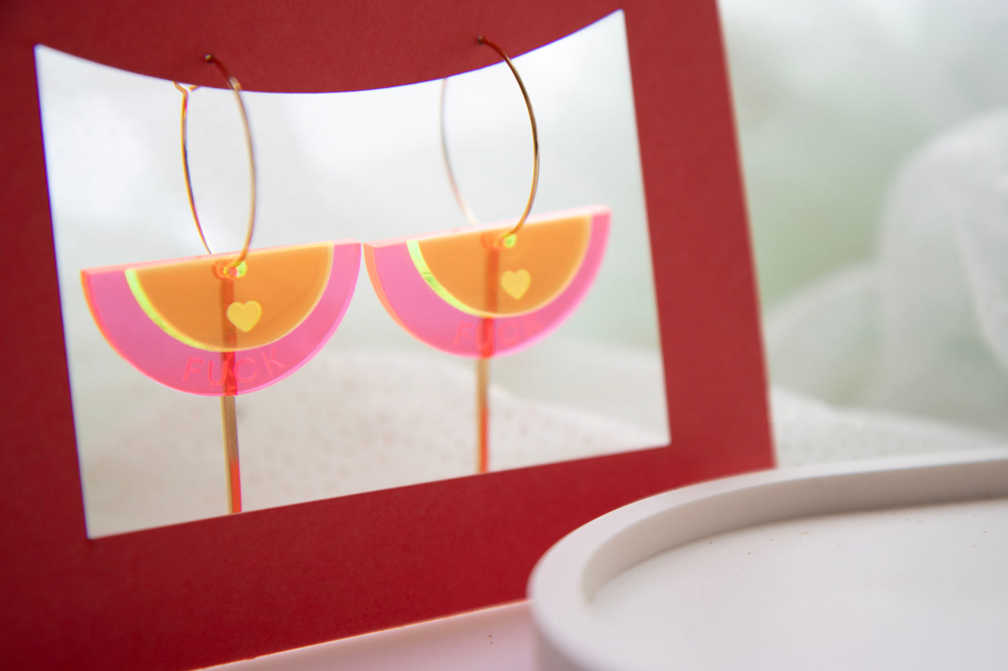 Gold-colored "FUCK" neon acrylic hoop earrings
