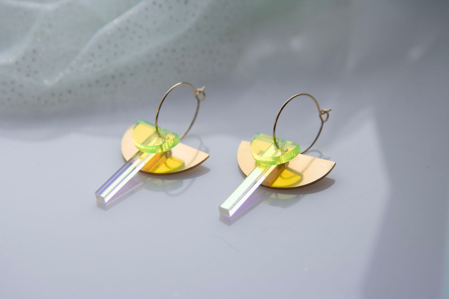 Geometric hoop earrings made of recycled neon acrylic iridescent