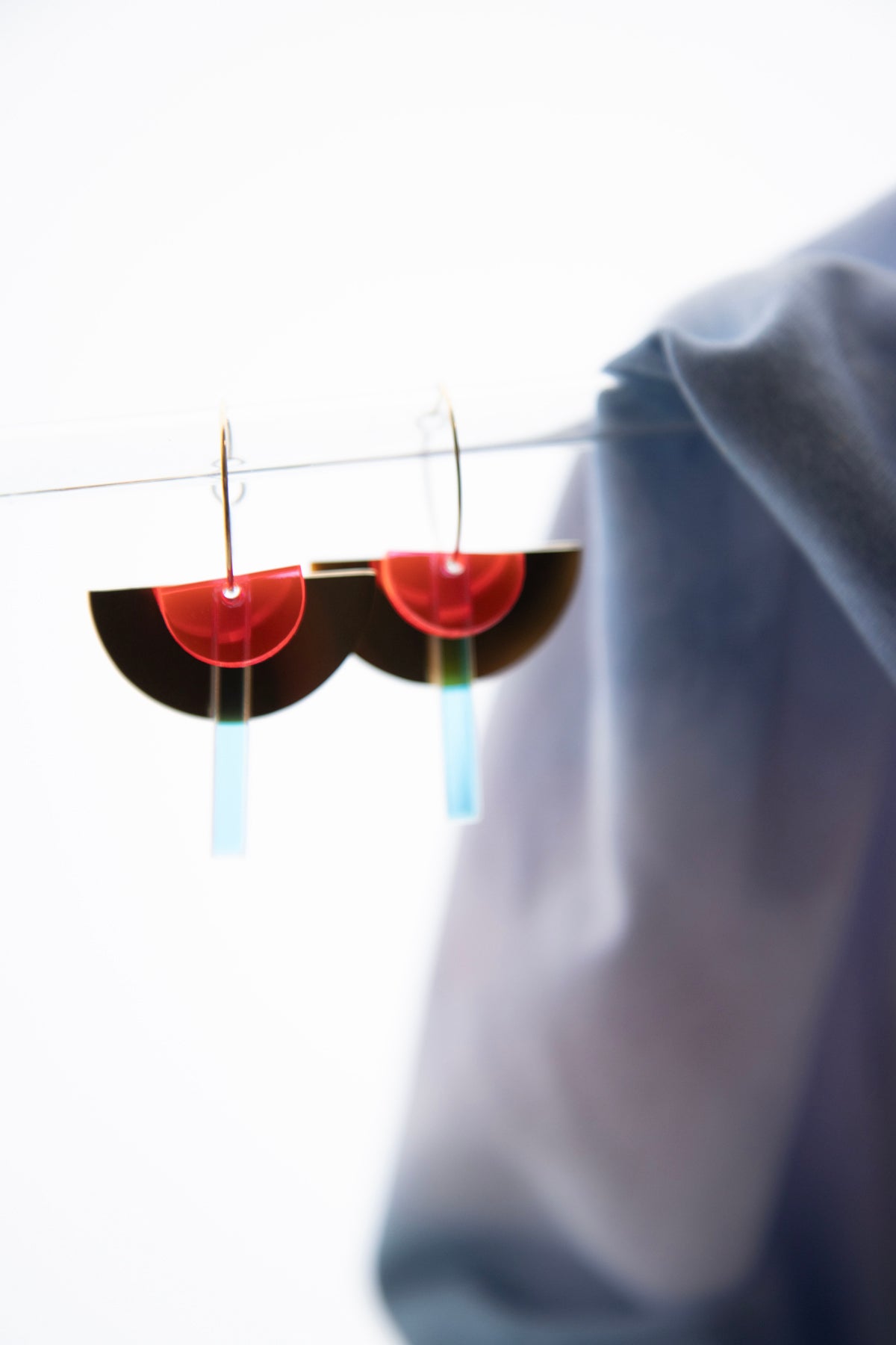 Geometric hoop earrings made of recycled neon acrylic iridescent