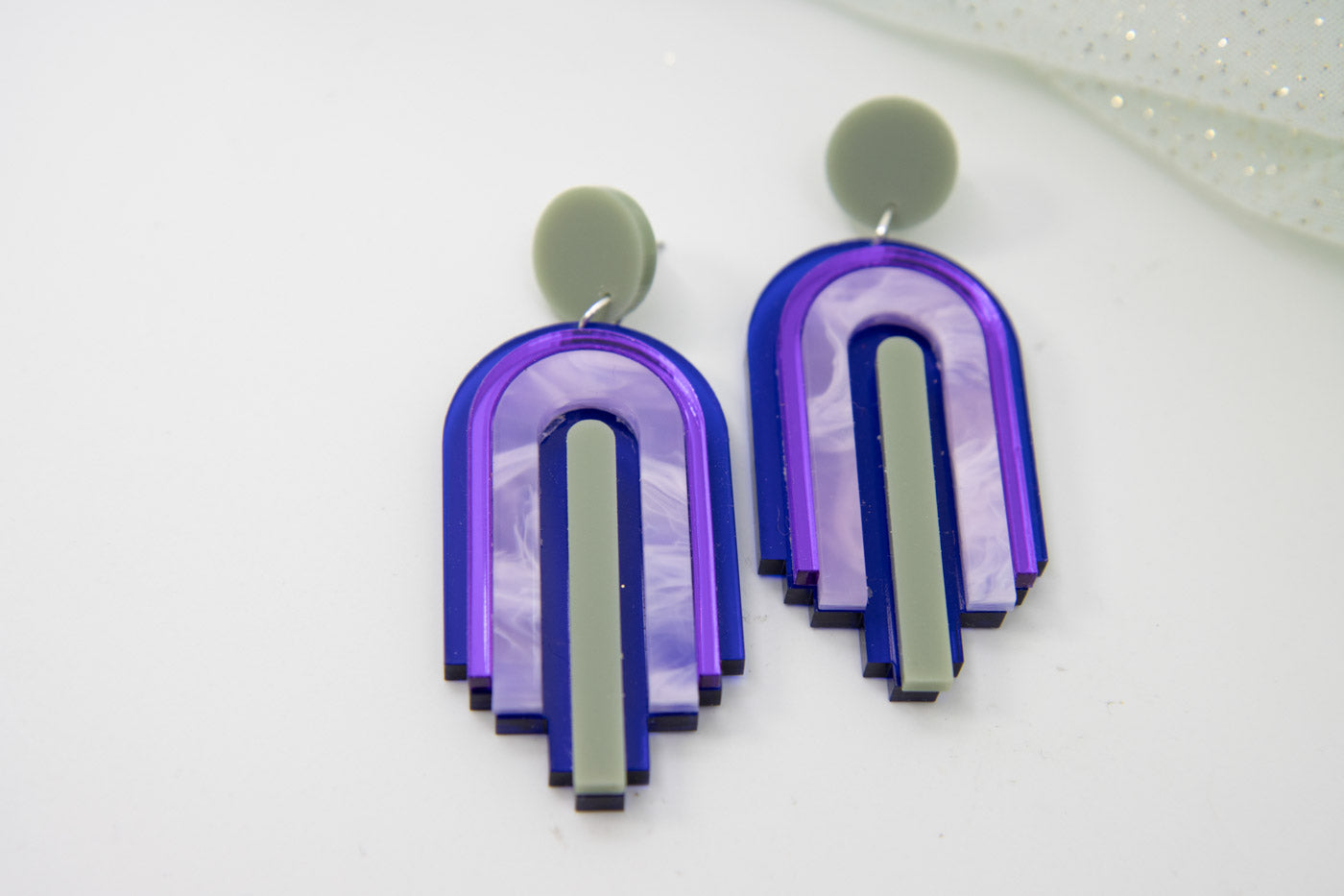 bow statement earrings – blue transparent & mirror purple laser jewelry